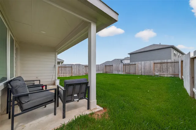 a view of a patio with a table and chairs