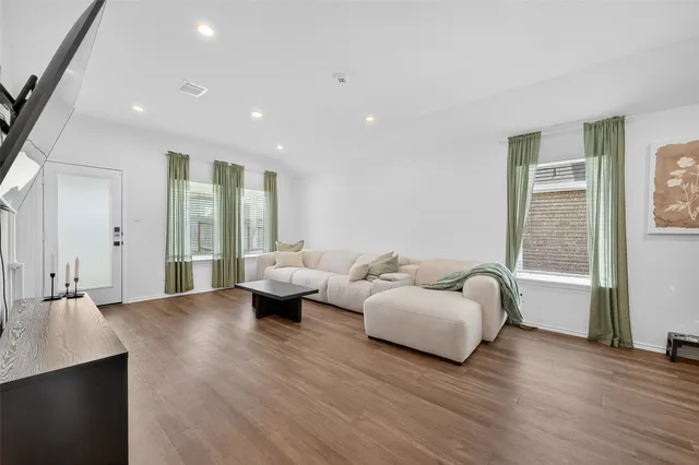a living room with furniture and wooden floor