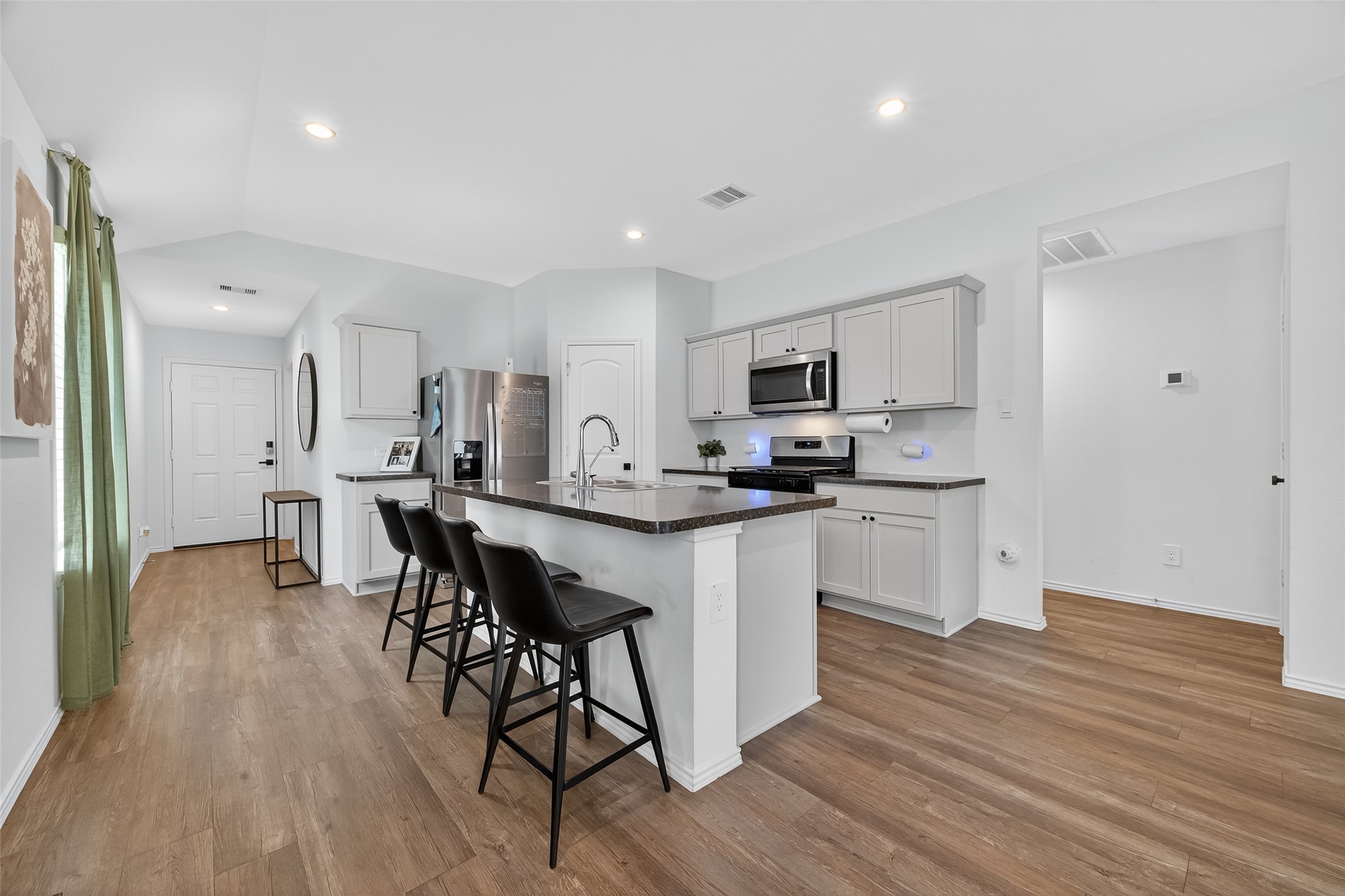 24422 Oriole Summit Drive Spring, TX 77373 - Photo 6 of 20 a kitchen with white cabinets and appliances
