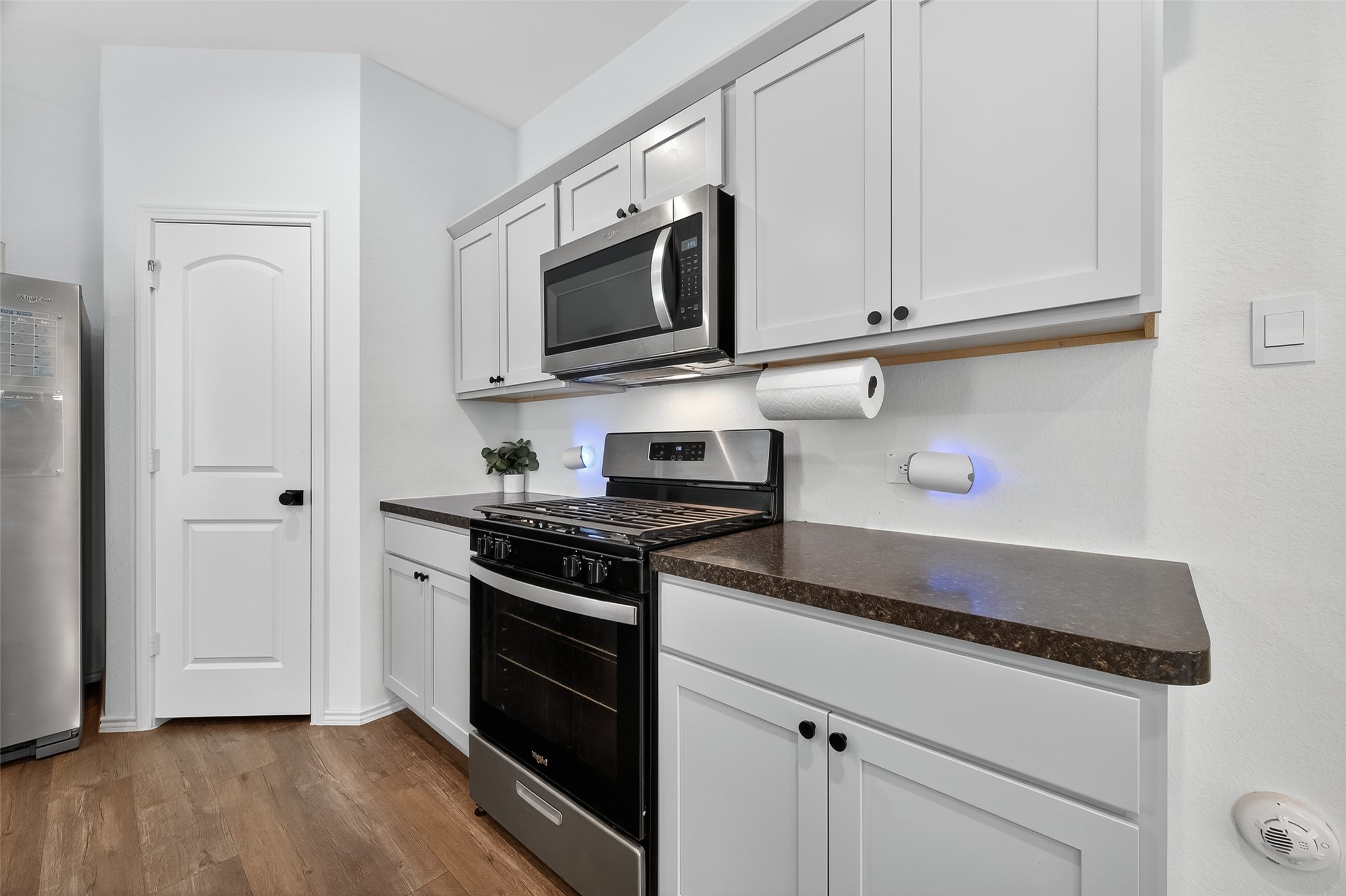24422 Oriole Summit Drive Spring, TX 77373 - Photo 7 of 20 a kitchen with stainless steel appliances granite countertop white cabinets and a stove top oven
