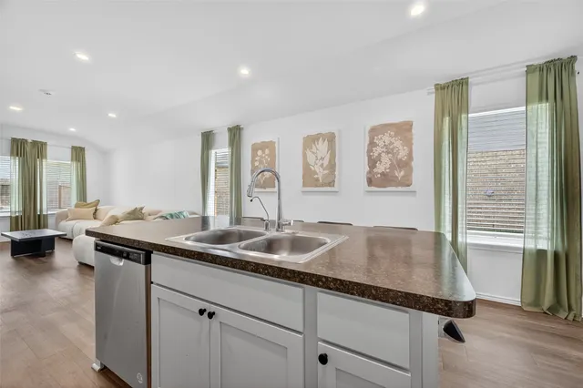 a kitchen with a sink and a refrigerator