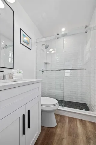 a bathroom with a sink a toilet and shower