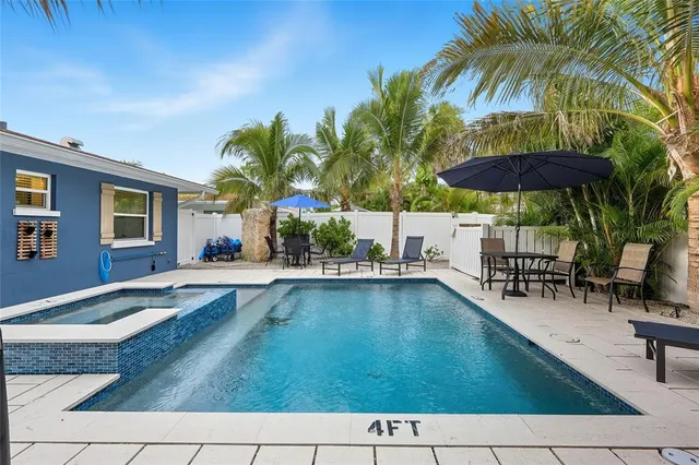 a swimming pool with outdoor seating yard and barbeque oven