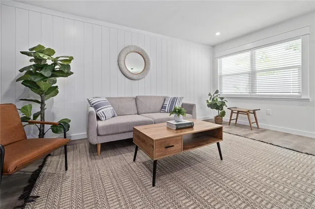 a living room with furniture and a potted plant