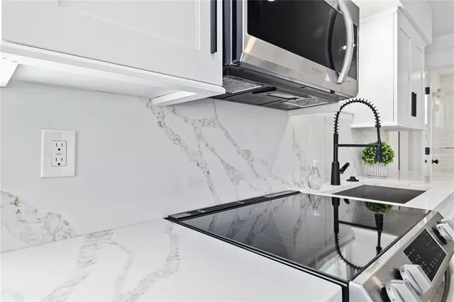 a bathroom with a granite countertop sink a toilet and shower