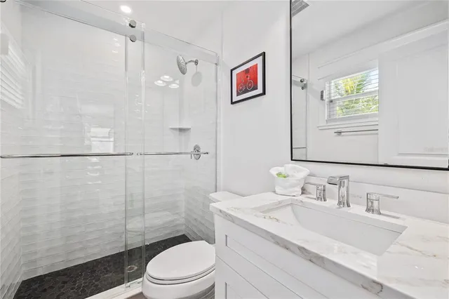 a bedroom with a bed and a potted plant