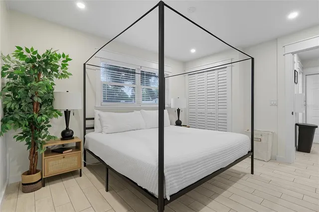 a view of a hallway with wooden floor and a potted plant