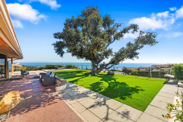 a swimming pool with outdoor seating and yard