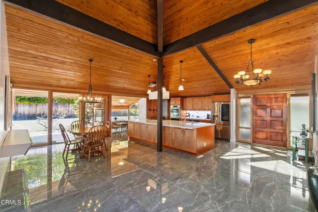 a bathroom with a sink and mirror with bathtub