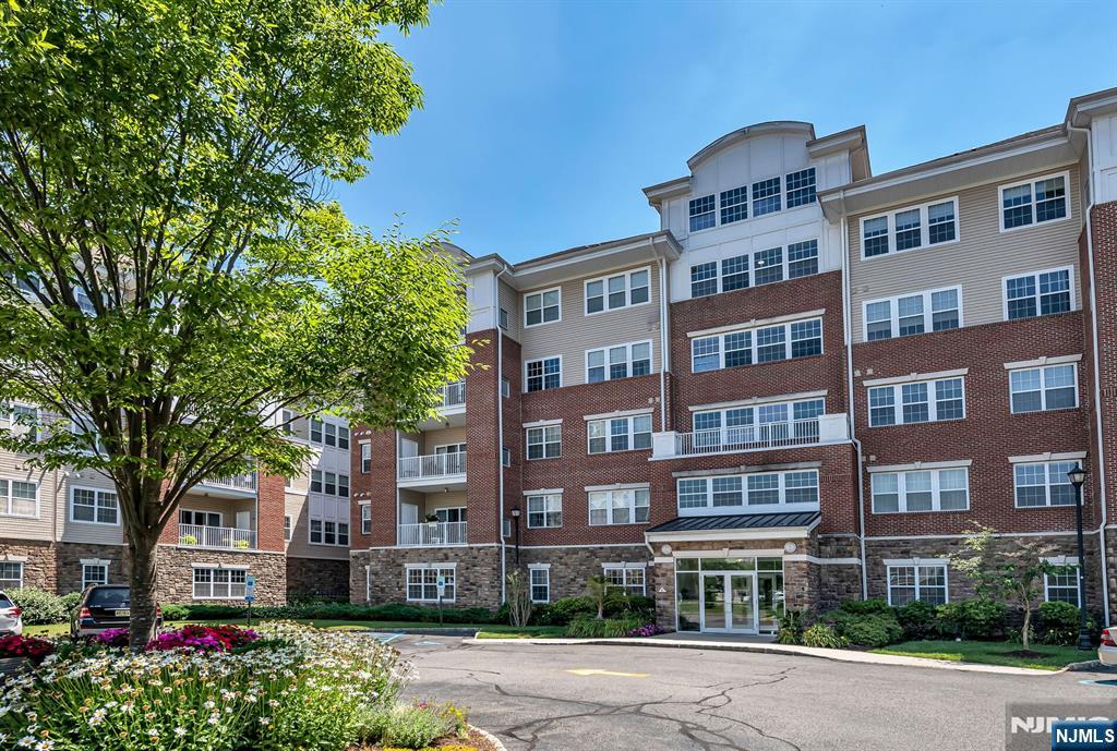 a front view of a multi story building with a yard