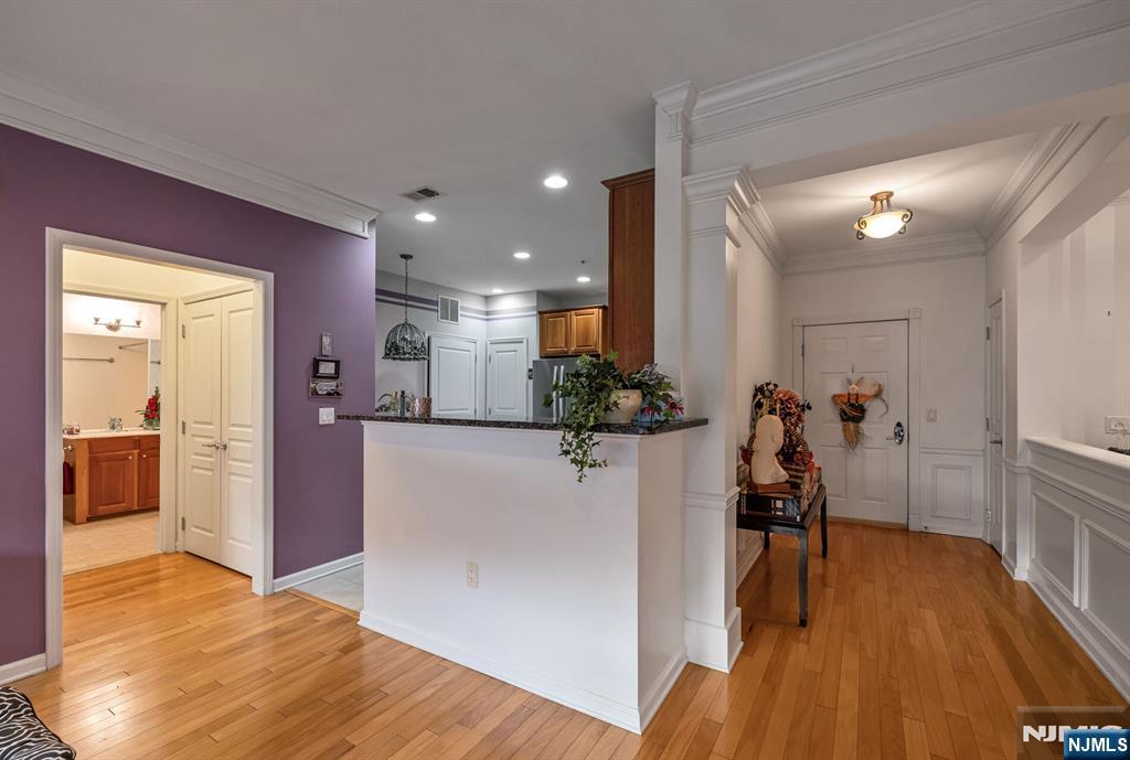 4203 Warren's Way Wanaque, NJ 07465 - Photo 10 of 35 a view of a hallway with wooden floor windows and a kitchen