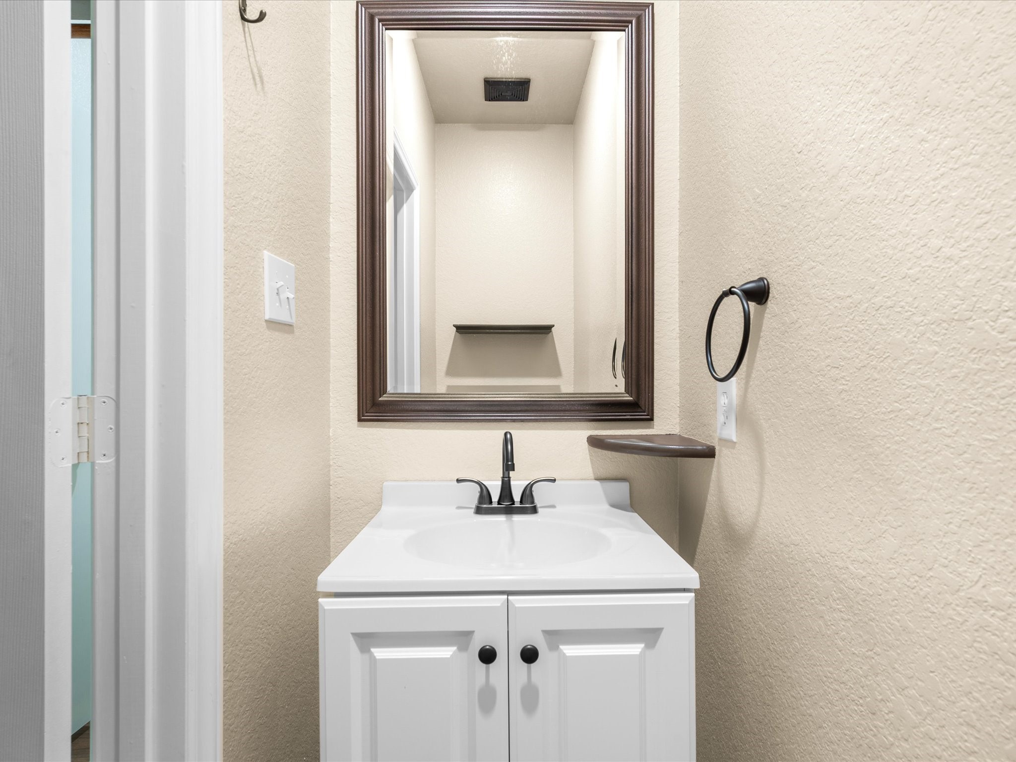 291 Sunset Path South Conroe, TX 77316 - Photo 17 of 39 A convenient half bath adds functionality for guests and everyday living.