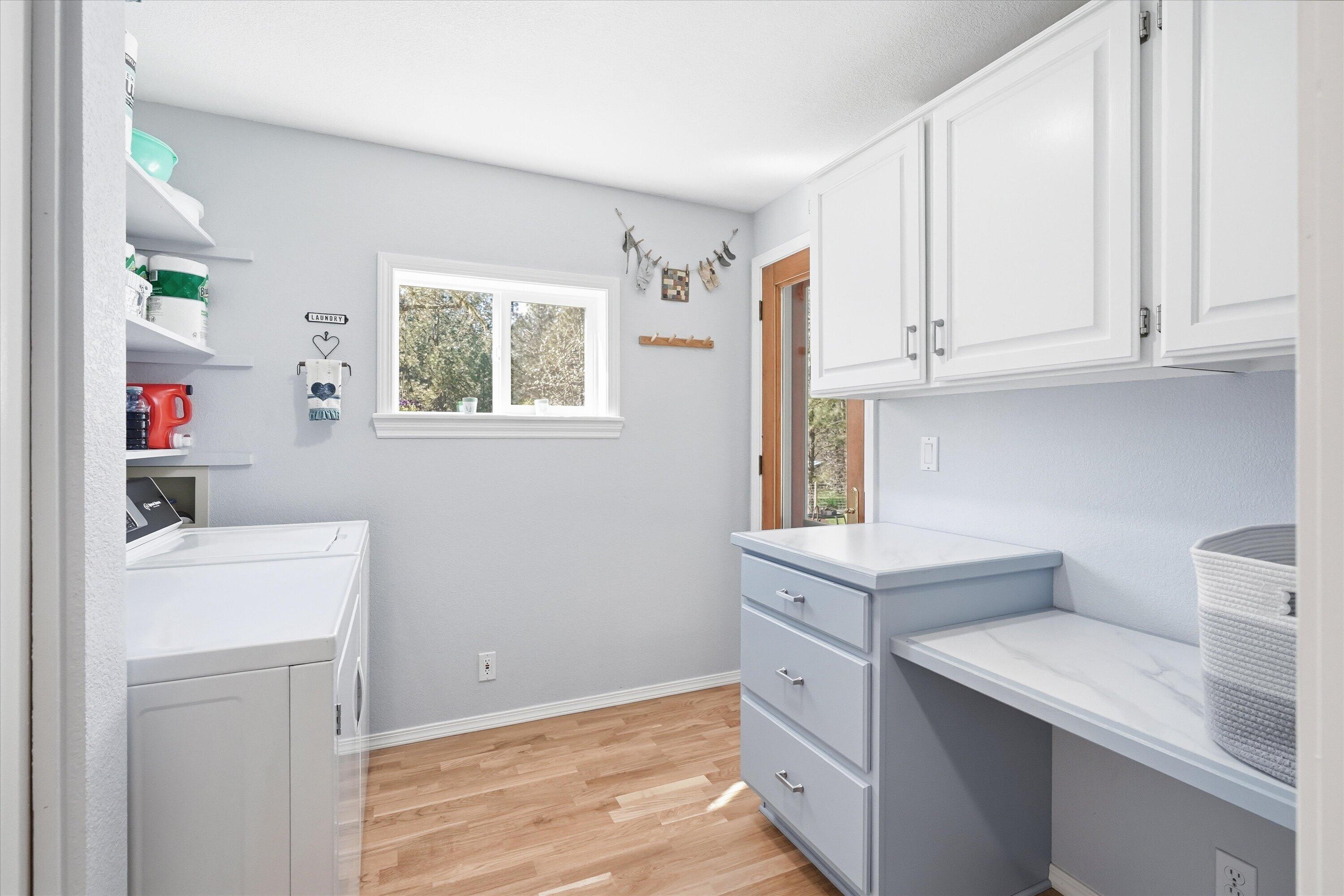 916 Ferry Road Grants Pass, OR 97526 - Photo 47 of 64 The laundry room has plenty of storage and a folding shelf for your convenience.