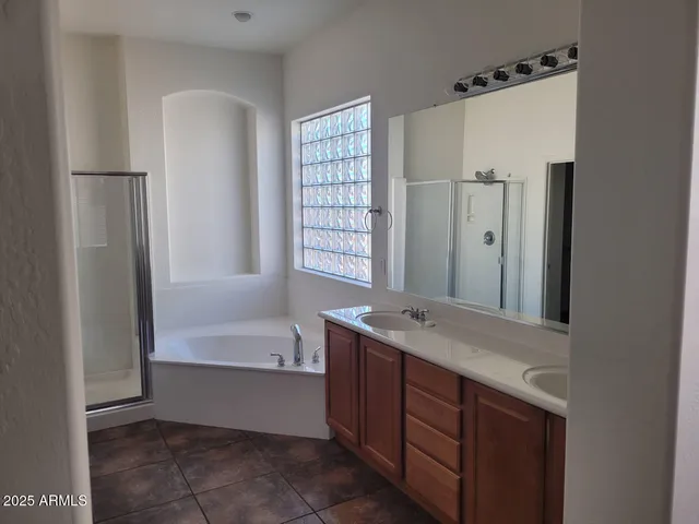 a bathroom with a tub sink and mirror