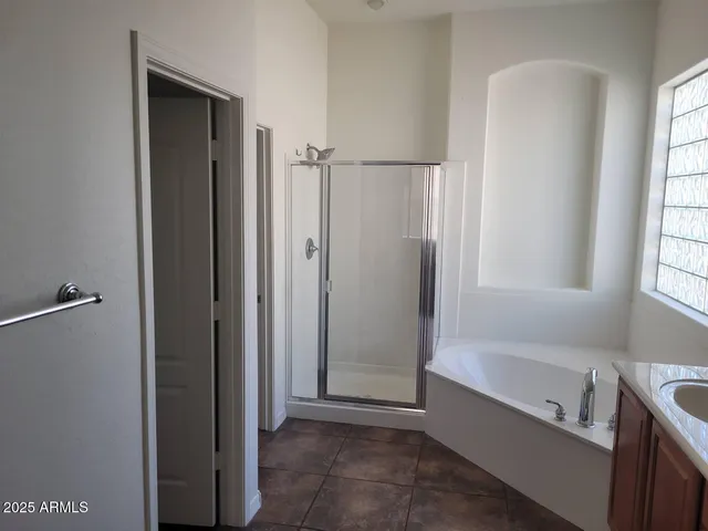 a bathroom with a bathtub and a shower