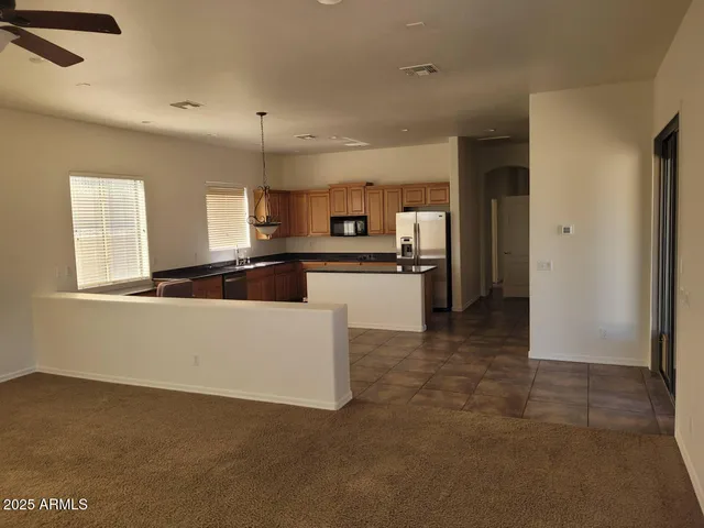 a kitchen with stainless steel appliances a refrigerator and a stove top oven