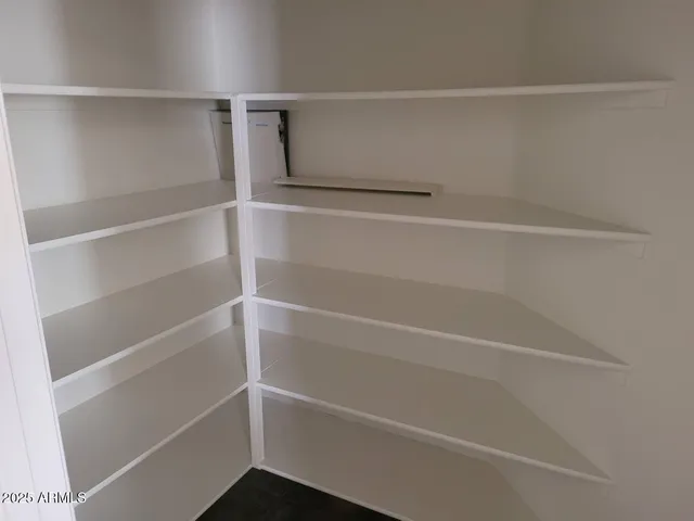 a kitchen with granite countertop a sink a counter top space appliances and cabinets