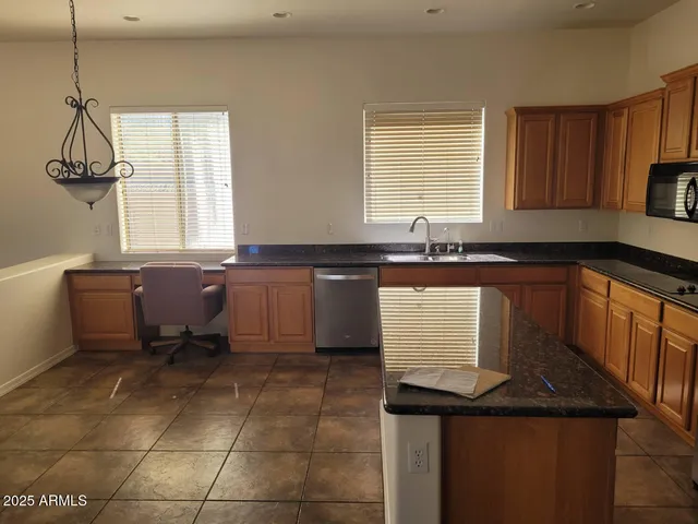 a kitchen with a sink a counter and cabinets