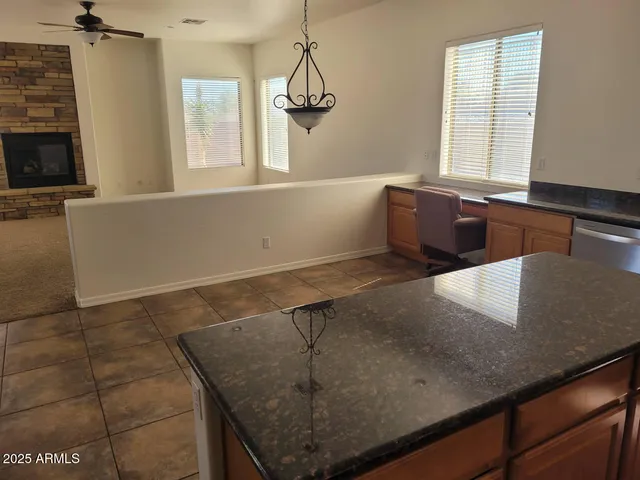 a view of a living room with a sink a window and chandelier