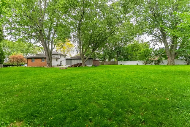 a view of a trees with a house in the background