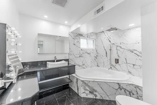 a bathroom with a bathtub and a sink