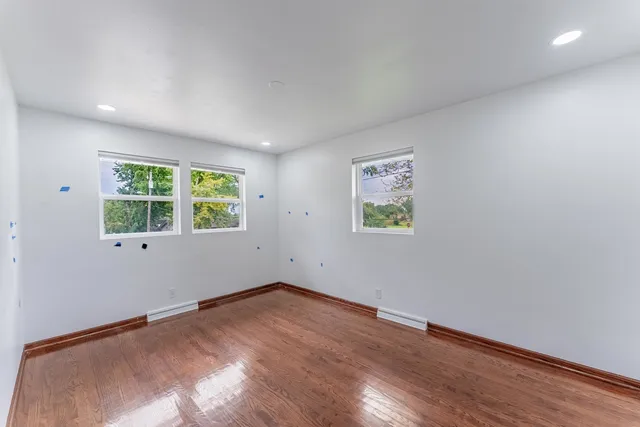 a view of a room with wooden floor and window