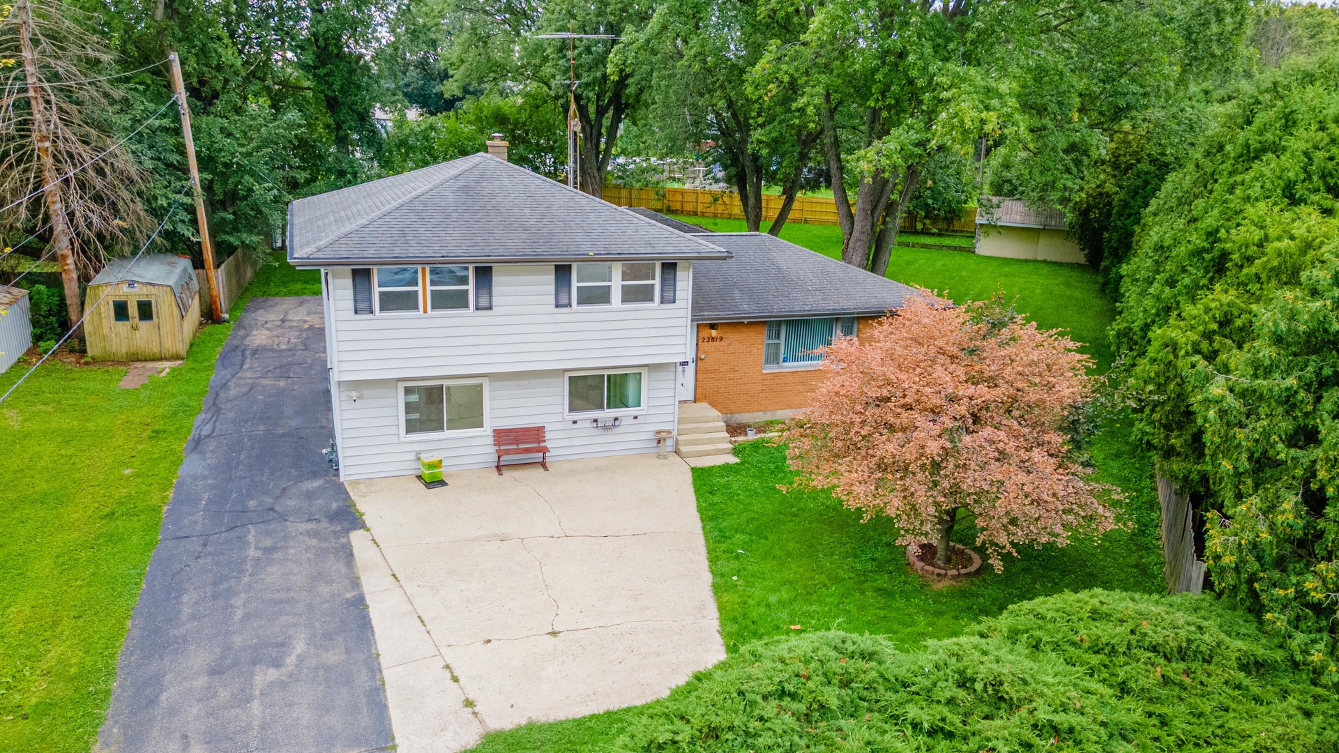 22819 Davy Court Plainfield, IL 60586 - Photo 6 of 36 a aerial view of a house with table and chairs under an umbrella
