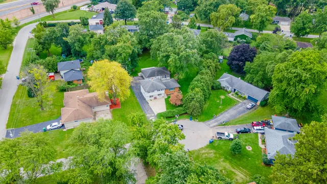 an aerial view of a house with a yard and lake view