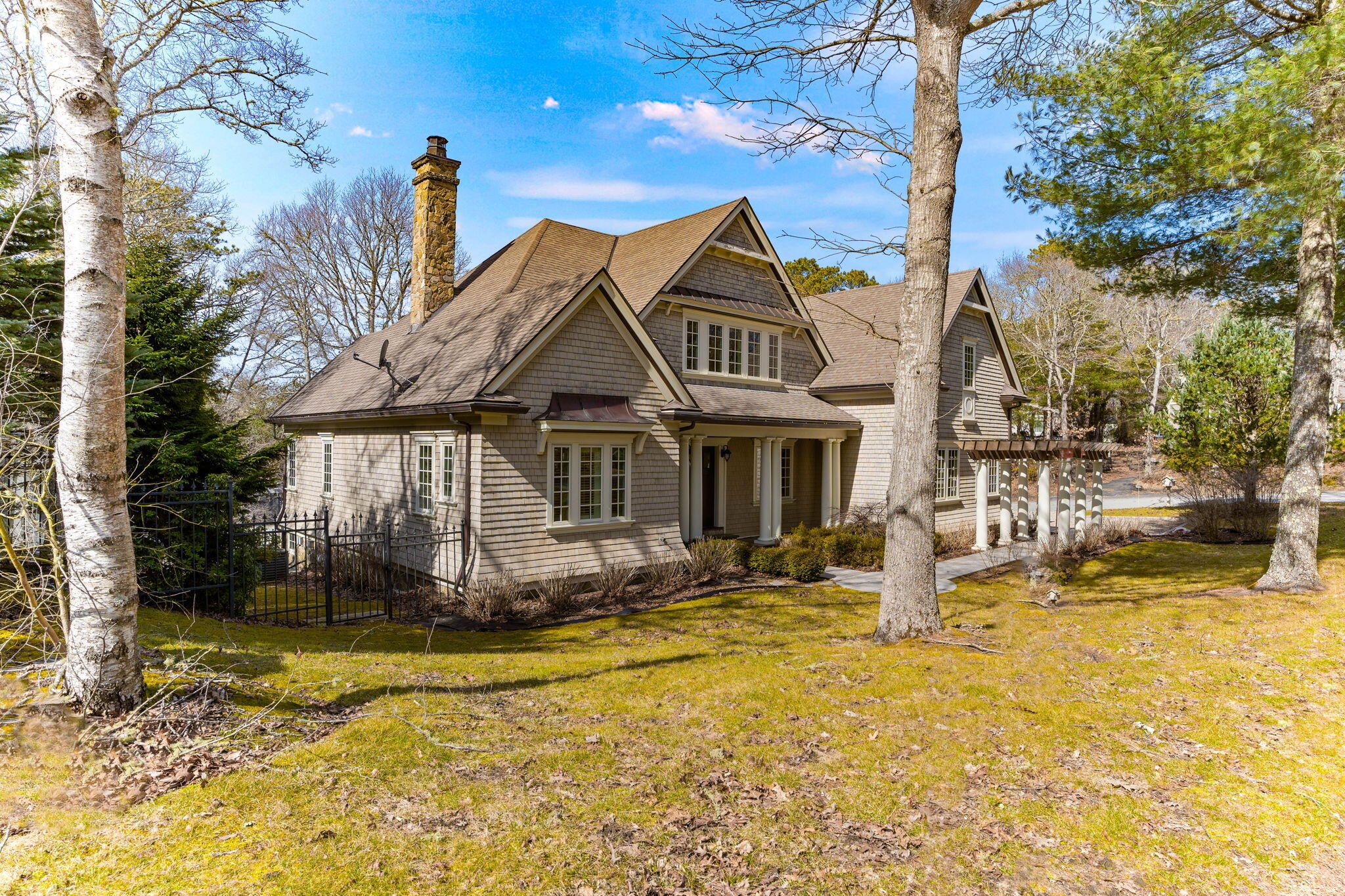 4 Vale Lane Mashpee, MA 02649 - Photo 2 of 33 a front view of a house with a yard covered with snow in front of it