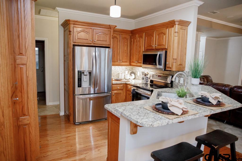 1614 Pineview Lane Hideaway, TX 75771 - Photo 12 of 48 a kitchen with a refrigerator and a stove top oven