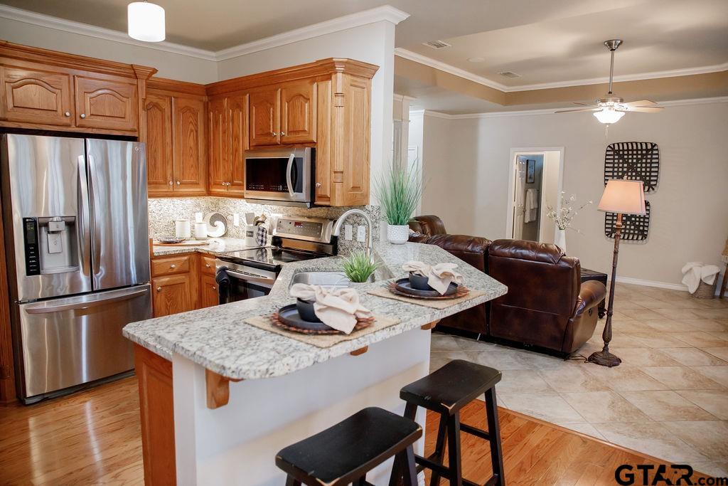 1614 Pineview Lane Hideaway, TX 75771 - Photo 13 of 48 a kitchen with a refrigerator a stove a sink dishwasher with a dining table and chairs