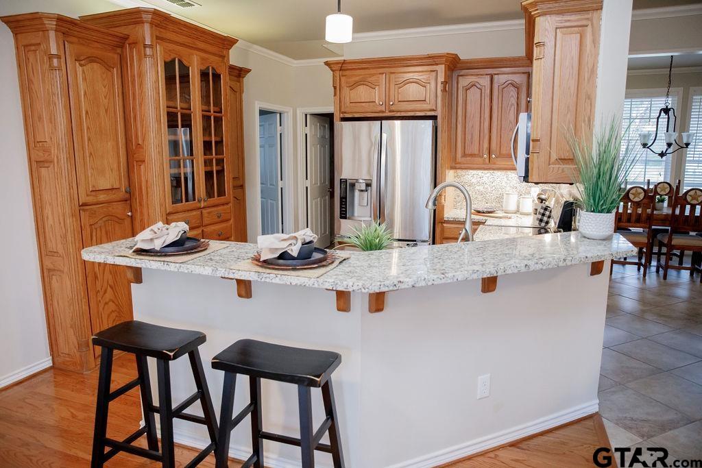 1614 Pineview Lane Hideaway, TX 75771 - Photo 15 of 48 a kitchen with a table chairs stove and cabinets