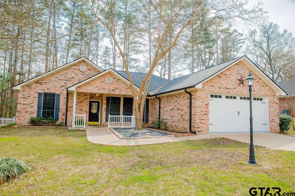 1614 Pineview Lane Hideaway, TX 75771 - Photo 2 of 48 a front view of house with yard outdoor seating and garage