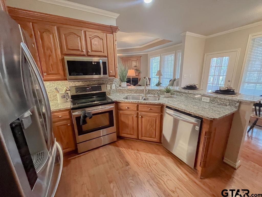 1614 Pineview Lane Hideaway, TX 75771 - Photo 43 of 48 a kitchen with stainless steel appliances granite countertop a stove a sink dishwasher a microwave oven and a refrigerator