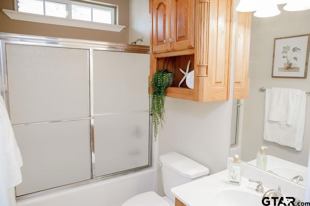 1614 Pineview Lane Hideaway, TX 75771 - Photo 7 of 48 a bathroom with a sink a toilet and shower