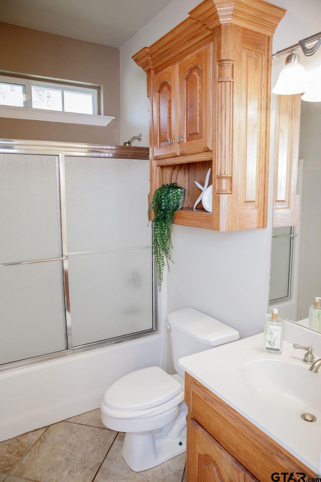 1614 Pineview Lane Hideaway, TX 75771 - Photo 8 of 48 a bathroom with a sink a toilet and shower