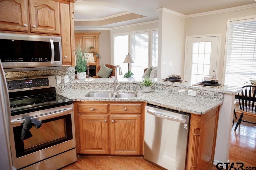 1614 Pineview Lane Hideaway, TX 75771 - Photo 10 of 48 a kitchen with granite countertop a stove and a sink