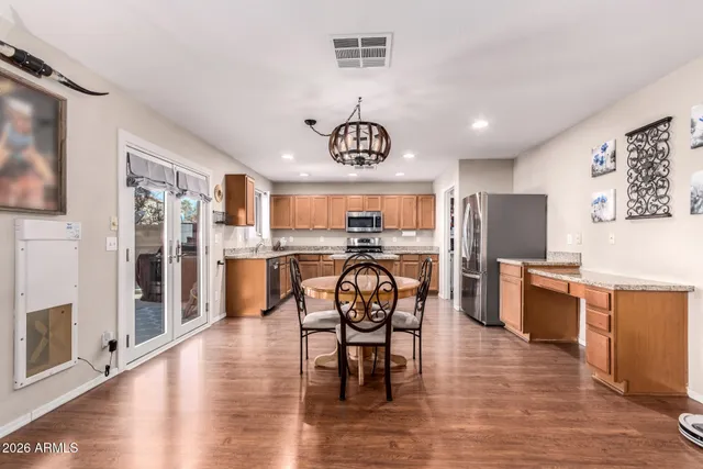 a view of a dining room with furniture wooden floor and a chandelier