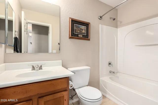 a view of a livingroom with furniture and a ceiling fan