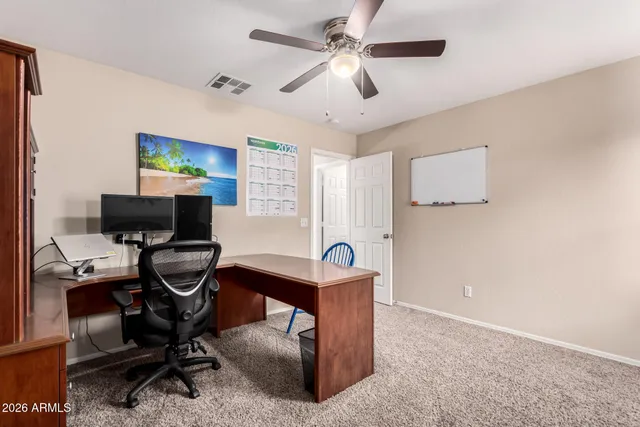 a view of a livingroom with furniture window and a ceiling fan