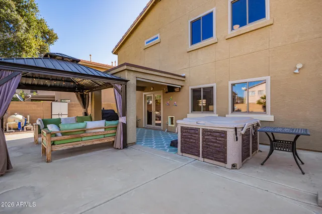 a view of swimming pool with lawn chairs and plants
