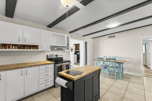 a kitchen with a stove a sink and a refrigerator