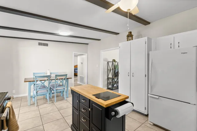 a kitchen with stainless steel appliances a refrigerator and a table