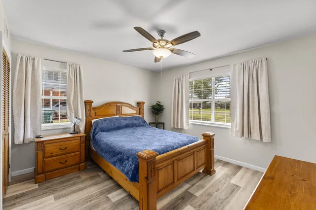 a bed sitting in a bedroom next to a window