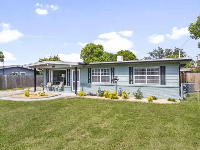 a front view of house with yard outdoor seating and barbeque oven