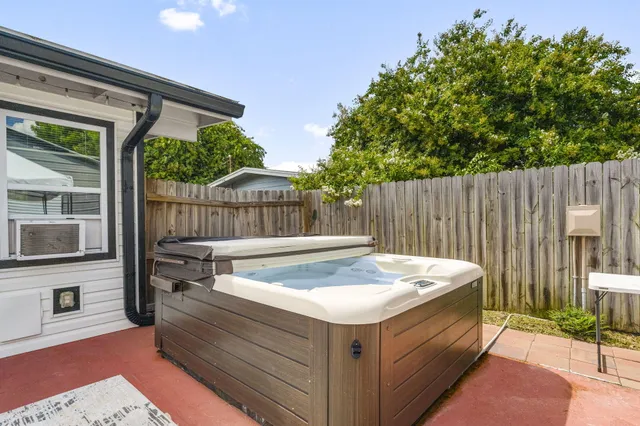 a view of a backyard with wooden fence