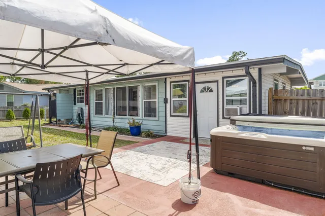 a view of a house with backyard porch and sitting area