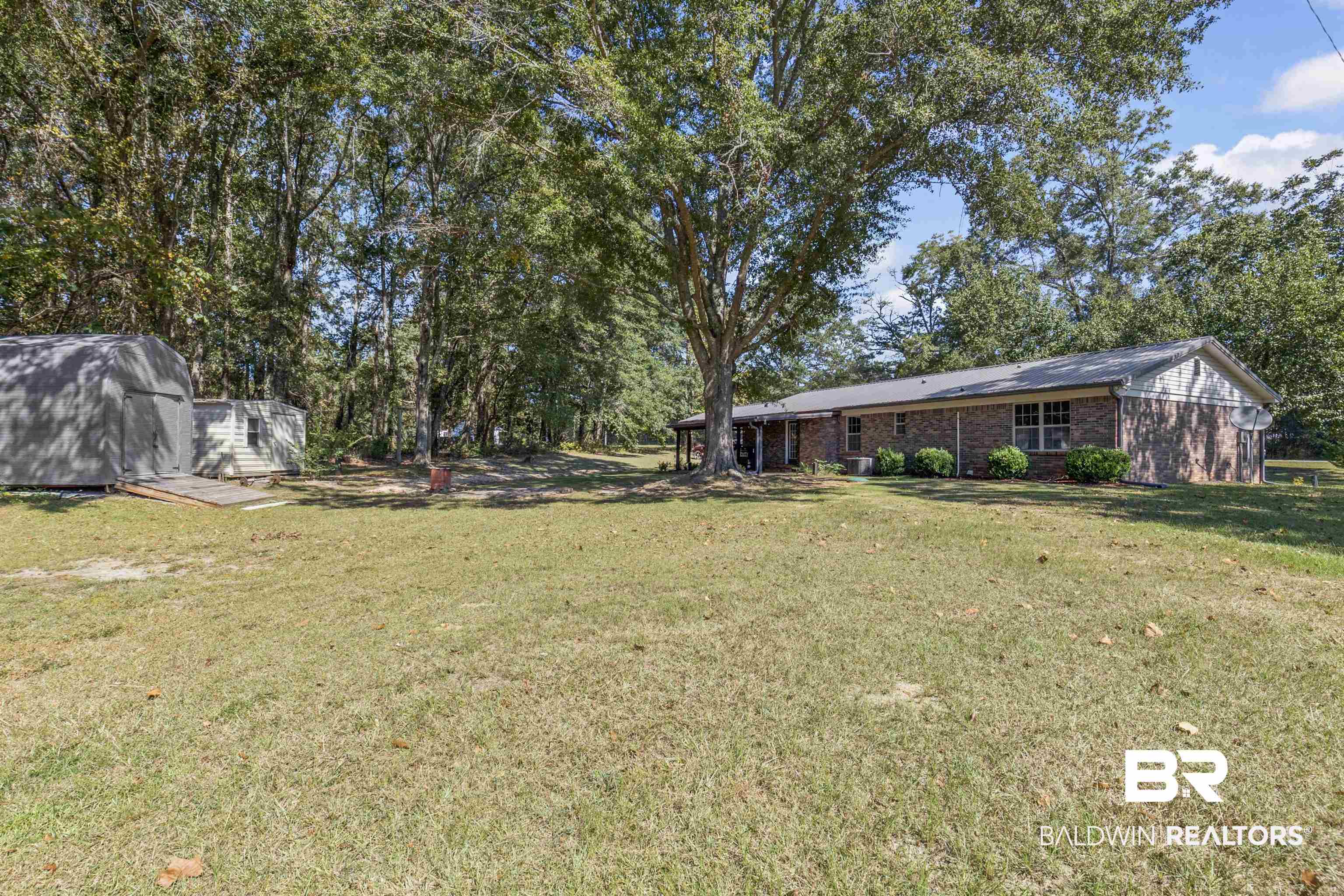 8911 Owassa Road Evergreen, AL 36401 - Photo 21 of 24 View of grassy yard with an outdoor structure