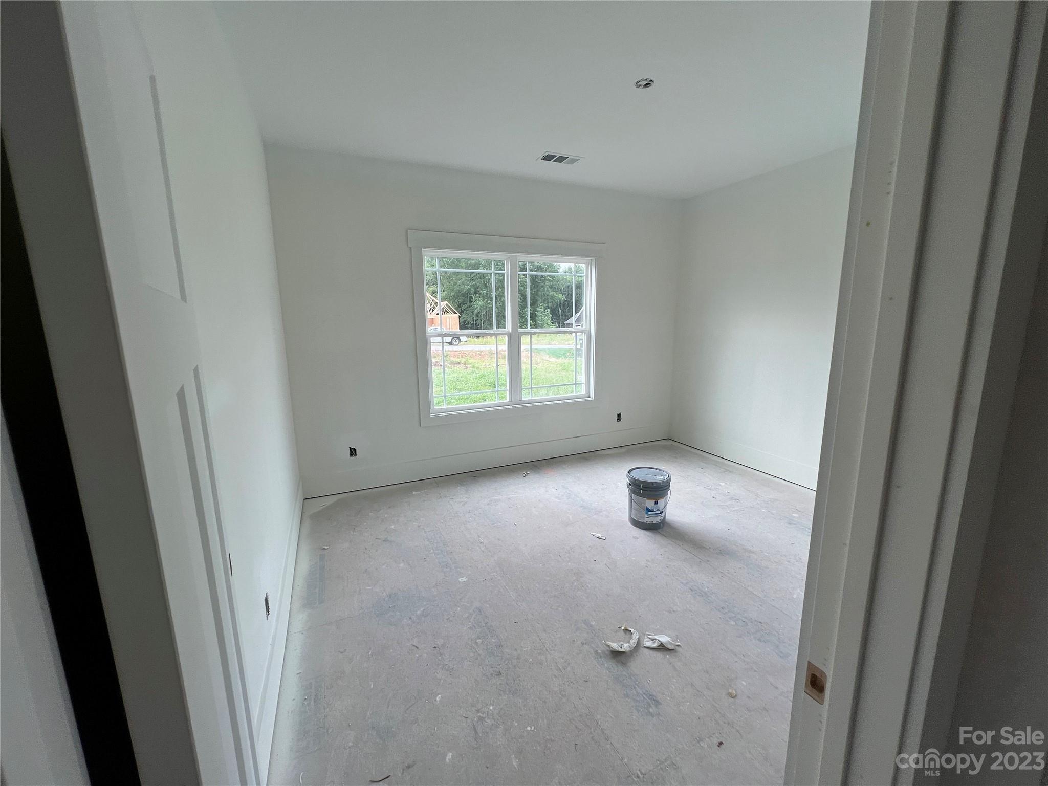 8018 Smooth Stone Court, Unit 71 Clover, SC 29710 - Photo 12 of 21 a view of an empty room with wooden floor and windows