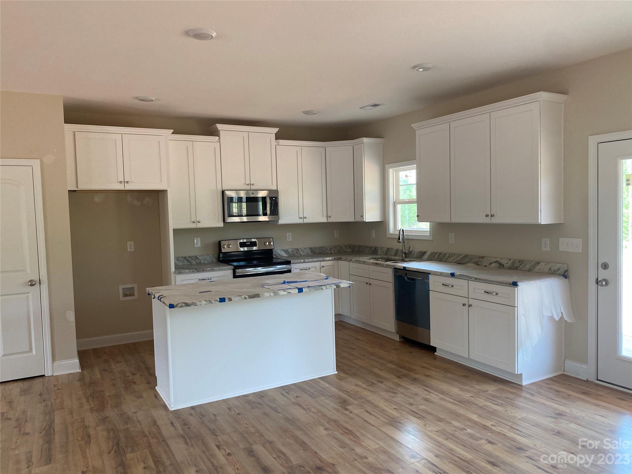 8018 Smooth Stone Court, Unit 71 Clover, SC 29710 - Photo 13 of 21 a kitchen with a refrigerator stove top oven and sink